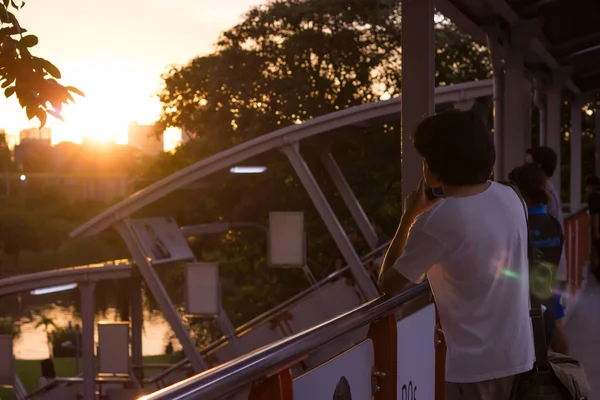 Young man watching the sunset, Bangkok, Thailand