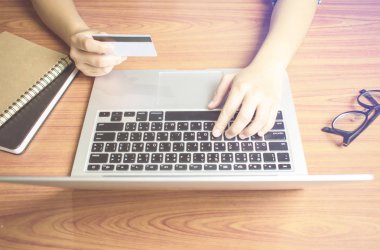 Üst görünüm, el bir kredi kartı tutarak, bilgisayara anahtar bilgileri. Online alışveriş