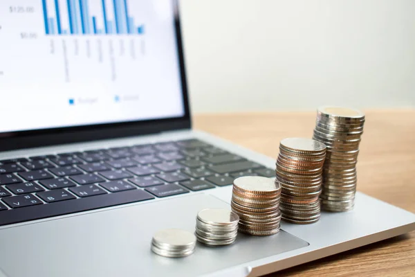 Stack a lot of coins on a laptop computer. — Stock Photo, Image