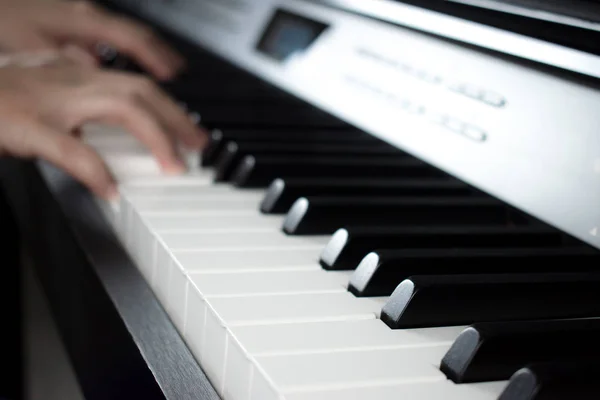 Blurred images of hands practicing piano in the music practice r