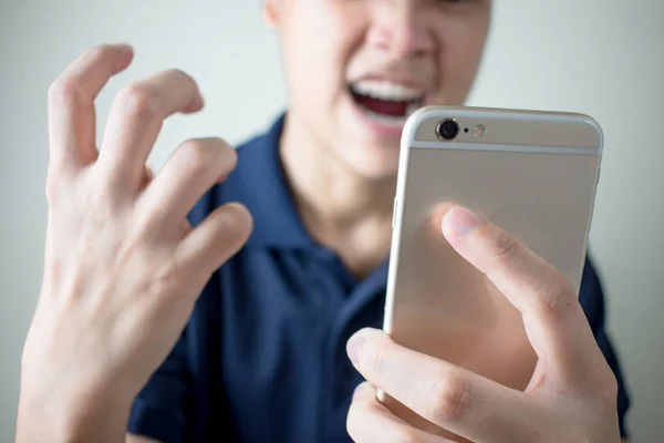 The young man felt angry from the smartphone with problems or er — Stock Photo, Image