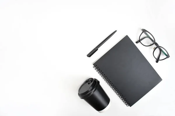 Vista superior de caderno, caneta, óculos e café em um bac branco — Fotografia de Stock