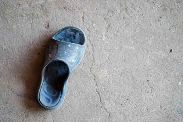 Gamla skor på cementgolvet, uppifrån. — Stockfoto