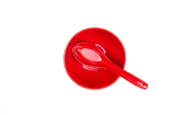 Top view, spoon in a red bowl. Isolated background. — Stock Photo, Image