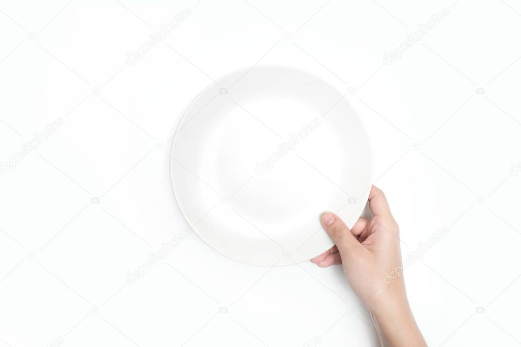 Close-up, holding a white plate on a white background. Isolated 