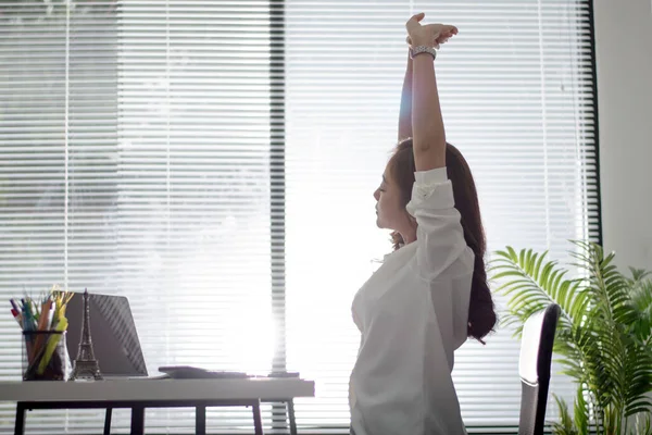 Asian working women relaxed from work at office.