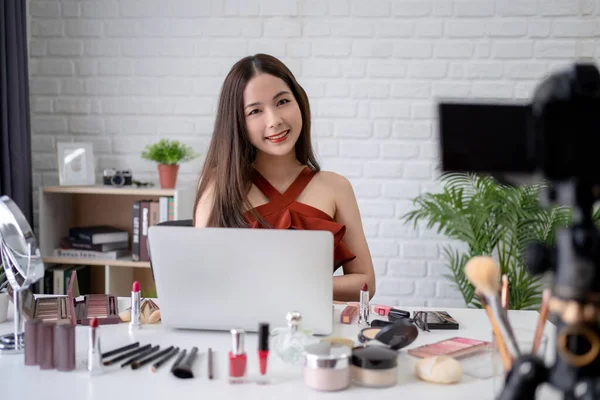 Professional makeup blogger and beautiful Asian woman are recording makeup tutorials to share on their website or social media.