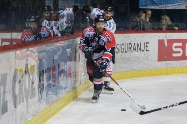 ZAGREB, CROATIA - DECEMBER 28, 2017: EBEL ice hockey league match between Medvescak Zagreb and Graz 99ers. Marko POYHONEN (39) and HIGGS Brock (23) in duel