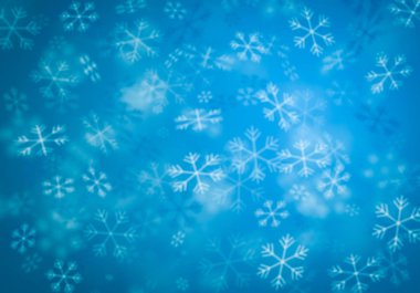 Mavi arka planda bulanık kar taneleri 