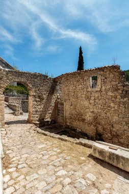 Taş yol, taş duvarlar ve terk edilmiş taş ev kalıntıları 