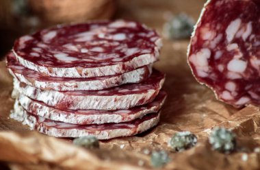 Rustik ahşap backgroun üzerinde zanaat kağıt üzerinde ceviz ile İtalyan salam