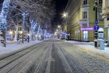 ZAGREB, CROATIA - JANUARY 07, 2016: Road covered with snow in cold winter night in center of Zagreb, Croatia