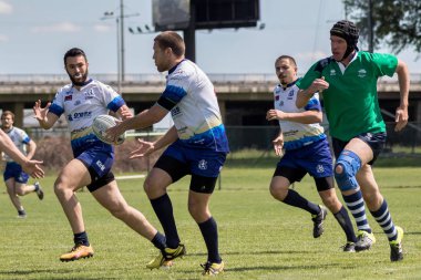 ZAGREB, CROATIA - MAY 6, 2017: Zagreb 7's - Rugby Tournament. Rugby players passing ball and running