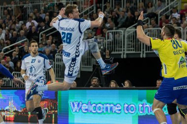 ZAGREB, CROATIA - MARCH 09, 2017: EHF Champions League PPD Zagreb VS RK Celje Pivovarna Lasko. MIKLAVCIC David (28) flying thru air holding ball in the hand 