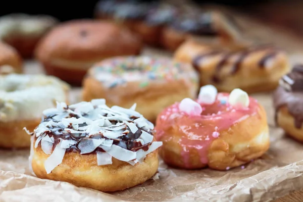 Delicious colorful donuts on baking paper