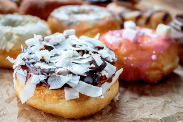 Delicious colorful donuts on baking paper