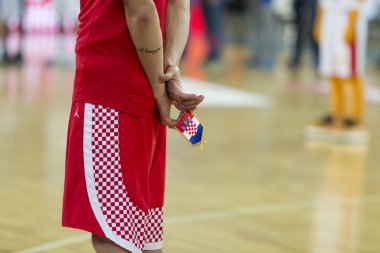 ZAGREB, CROATIA - AUGUST 28, 2015: The preparatory match ahead of the EuroBasket 2015 between Croatia and Israel. Croatian player holding Croatian flag in the hand.