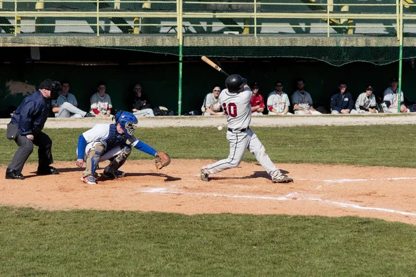 iZAGREB, CROATIA - MARCH 21, 2015: Baseball match Baseball Club Zagreb in blue jersey and Baseball Club Olimpija in gray jersey. Baseball batter, catcher and plate umpire