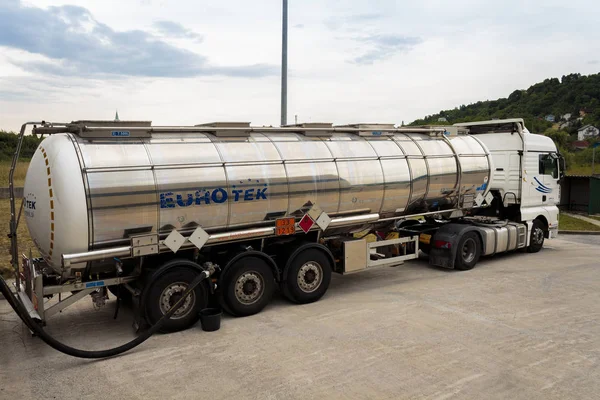 ZAGREB, CROATIA - JUNE 23, 2015: Tank truck unloading dangerous flammable goods Isopropyl alcohol into the inner tank storage of chemicals warehouse