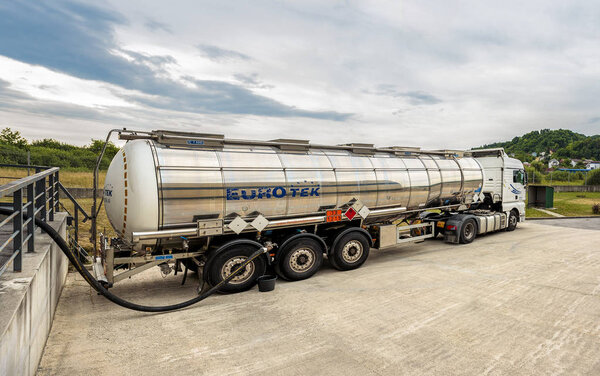 ZAGREB, CROATIA - JUNE 23, 2015: Tank truck unloading dangerous flammable goods Isopropyl alcohol into the inner tank storage of chemicals warehouse