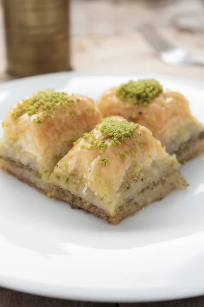 Baklava with pistachios and walnuts on white plate