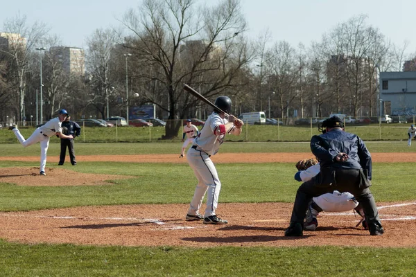 ZAGREB, CROATIA - MARCH 21, 2015: Baseball match Baseball Club Zagreb in blue jersey and Baseball Club Olimpija in gray jersey. Pitcher throwing the ball and batter is ready to hit it