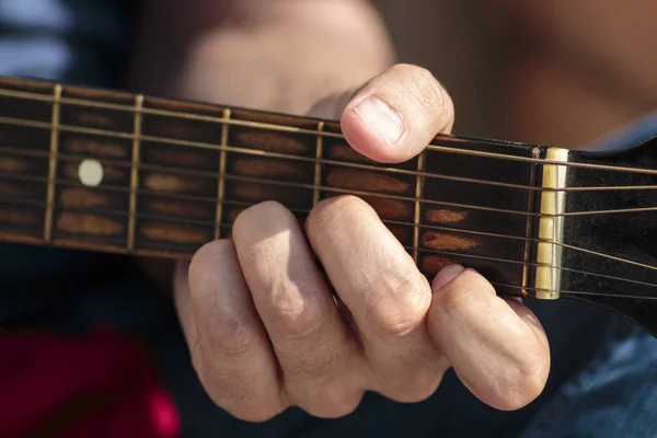 Left hand position of basic chord on the old classic guitar