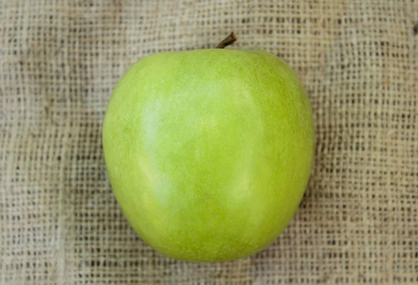 Granny Smith apple on the burlap background