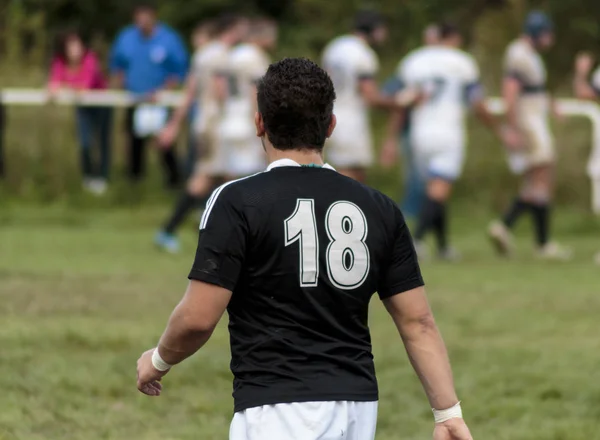 Rugby player walking on field
