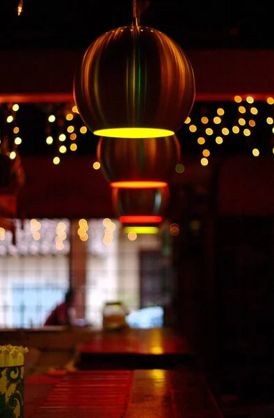 A bar is lighted with cozy lamps and a cute decor
