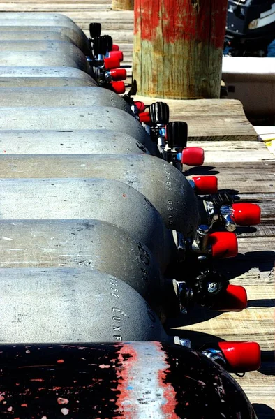 Bunch of oxygen bottles ready to be used by a flock of tourists diving at Roatan island in Honduras