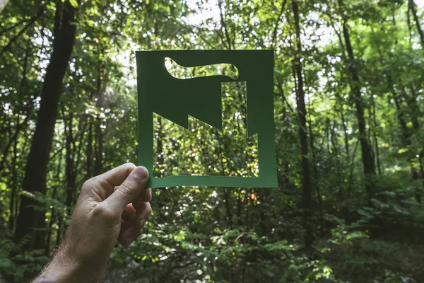 Hand holding eco friendly green living symbol