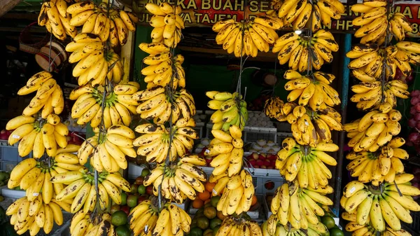 Fruit shops in traditional markets in Indonesia sell bananas that are neatly arranged and displayed in front of the shop