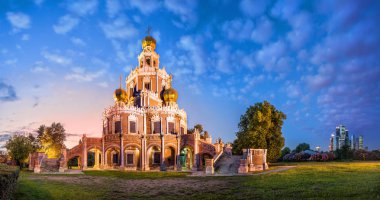 Church of the Intercession in Fili in Moscow and Moscow city in the background summer evening clipart