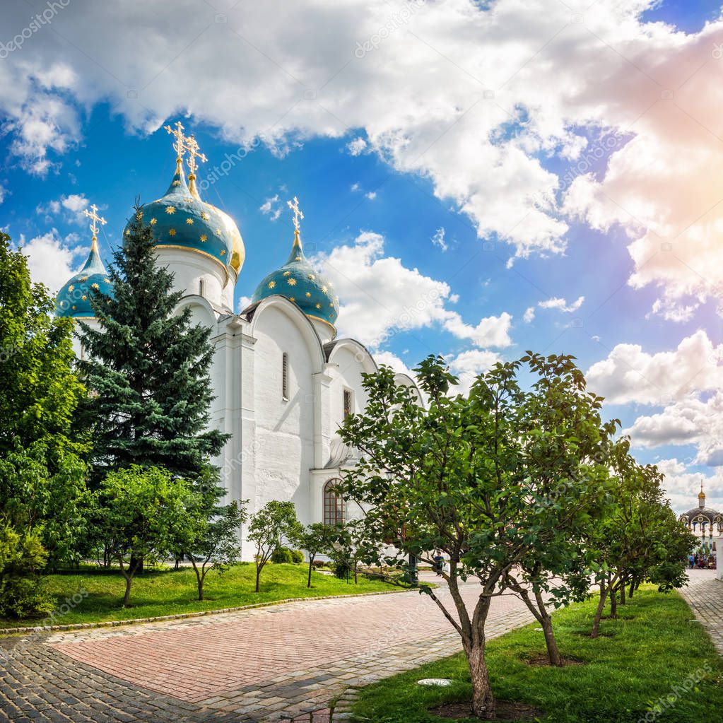 The Assumption Cathedral in the Lavra in Sergiev Posad on a summer sunny day and clouds in the sky