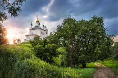Assumption Church on the Fedosino Hill hillfort in the town of Epifan, Tula Region, and green summer vegetation clipart