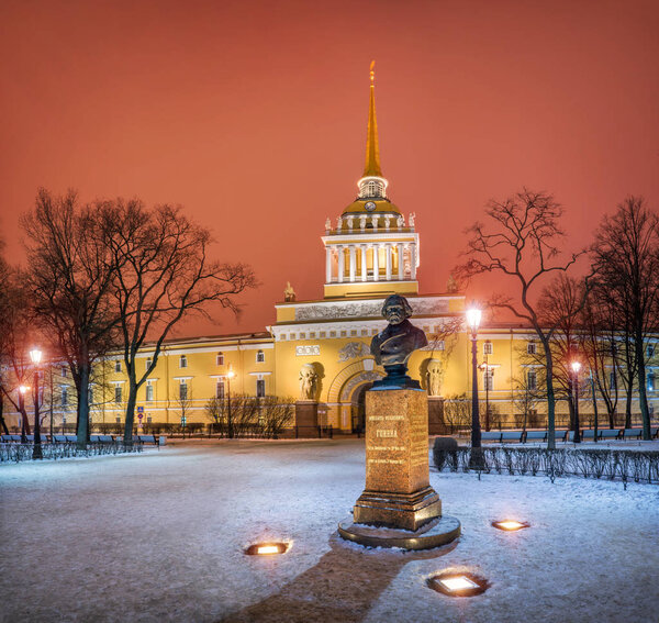 The Admiralty building in St. Petersburg and the monument to russian composer Glinka on a winter night. The inscription on the monument: Mikhail Ivanovich Glinka, date of birth, date of death.