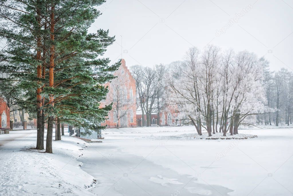 Pavilion Admiralty in Tsarskoye Selo on the Big Pond and green pines in the winter snowy day