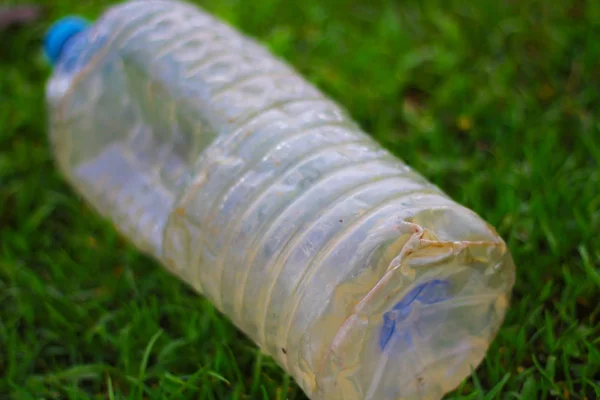 Plastic pollution - Plastic bottle is fallen down in the grass