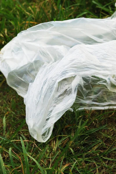 Plastic pollution - polythene is lying down in the grass — Stock Photo, Image