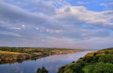 White clouds over a quiet river