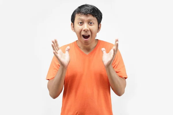asian guy shocked with orange t-shirt. chinese man funny using orange t-shirt