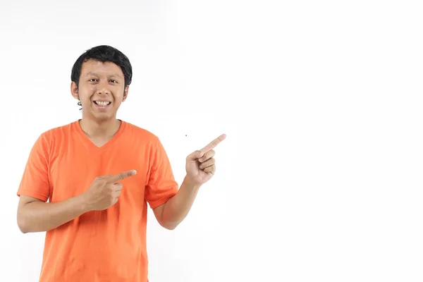 Felice Studente Indonesiano Che Indica Spazio Vuoto Utilizzando Arancione Shirt — Foto Stock
