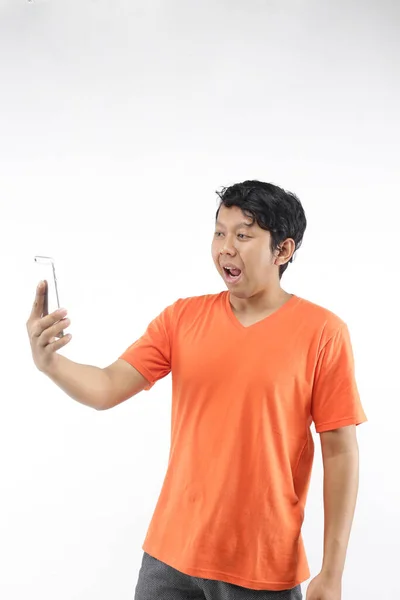 Shocked Chinese Man Looking Smartphone Using Orange Shirt — Stock Photo, Image