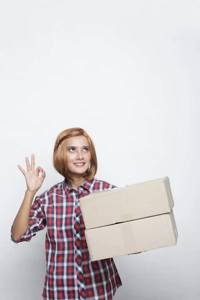 delivery woman ok with parcel box. Delivery woman making OK sign with shirt colorful