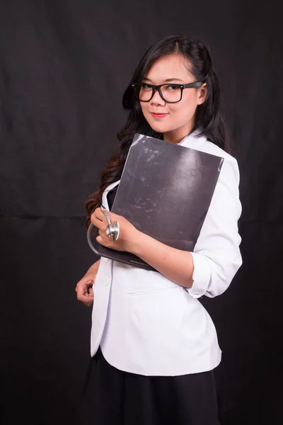 indonesia woman doctor holding stethoscope, report on white background