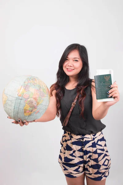 indonesia woman traveling for holiday holding passport, globe, and map on white background