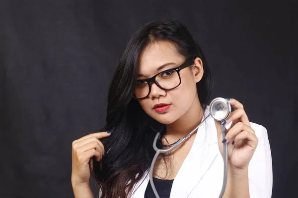 indonesia woman doctor holding stethoscope, report on white background