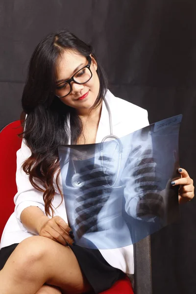 indonesia woman doctor holding stethoscope, report on white background