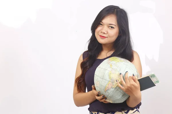 indonesia woman traveling for holiday holding passport, globe, and map on white background